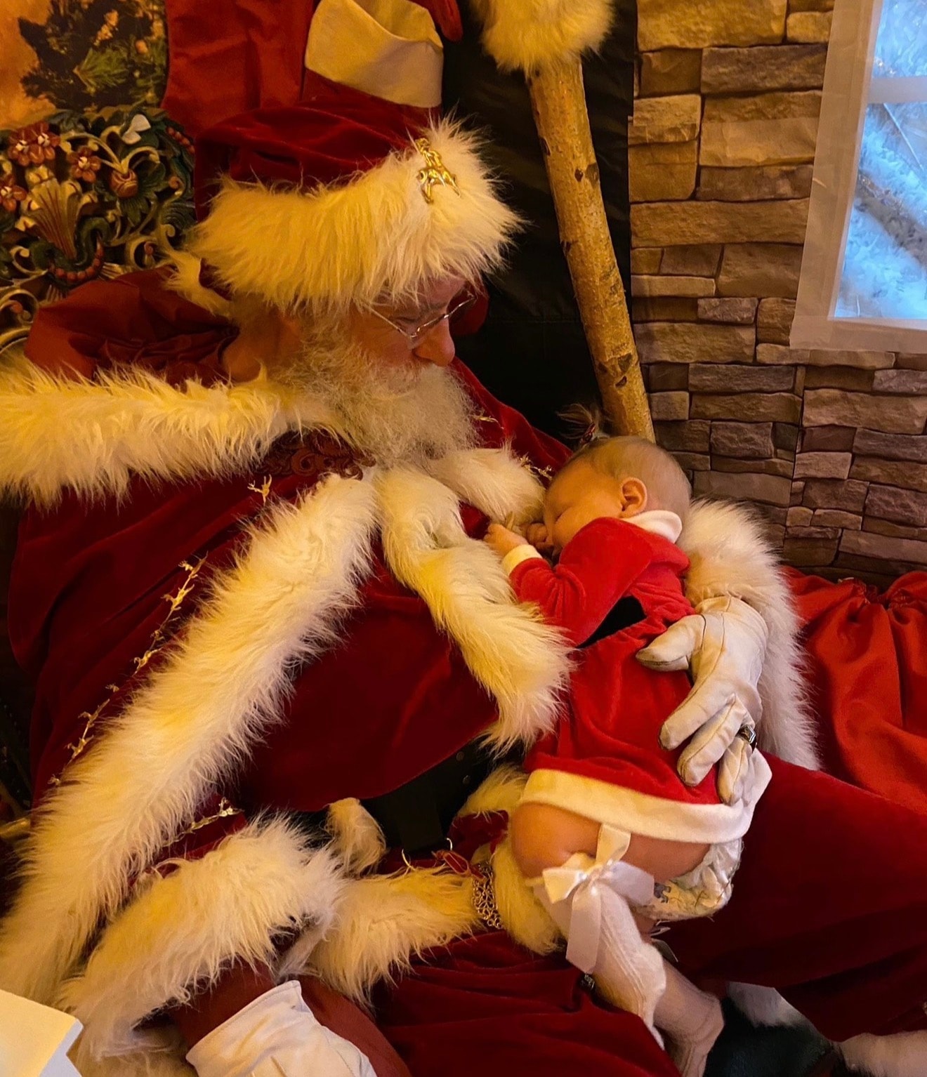 Santa cradling a baby at Christmas